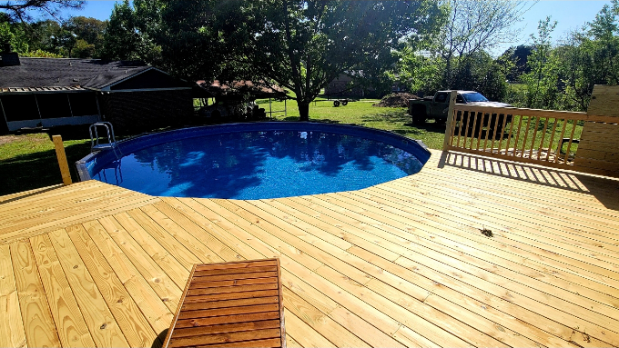 Round above-ground pool with new decking